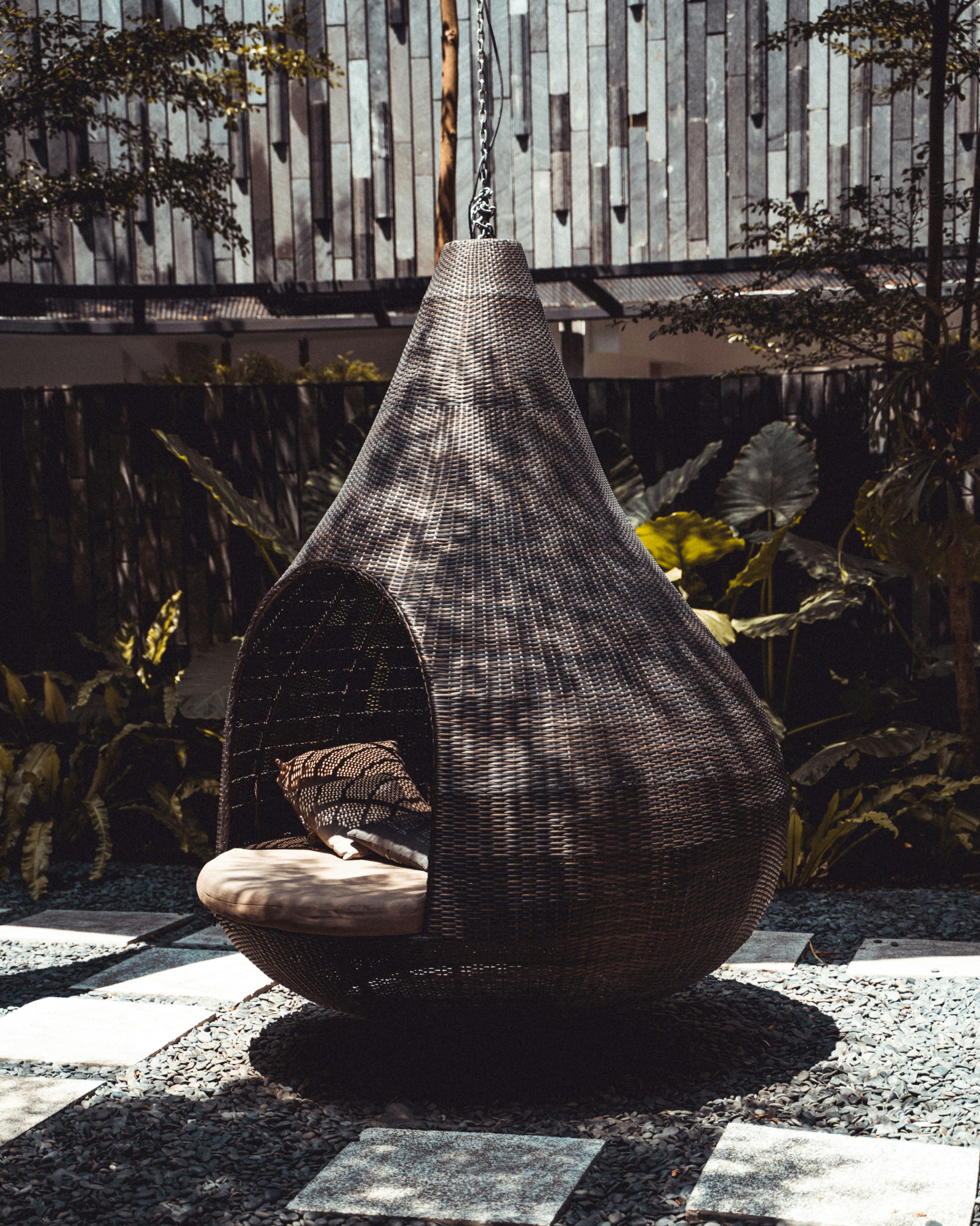 brown throw pillow in swing close-up photography